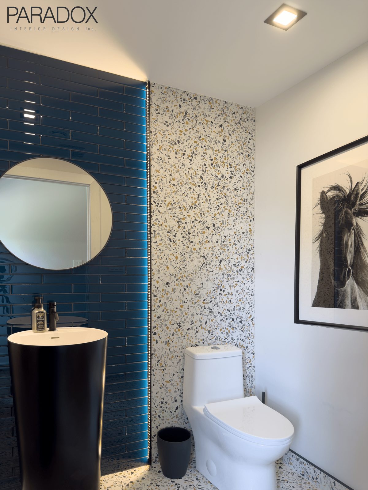 Lake house powder room in Ontario with terrazzo tile floor and bright blue illuminated glass tile feature wall, view 2