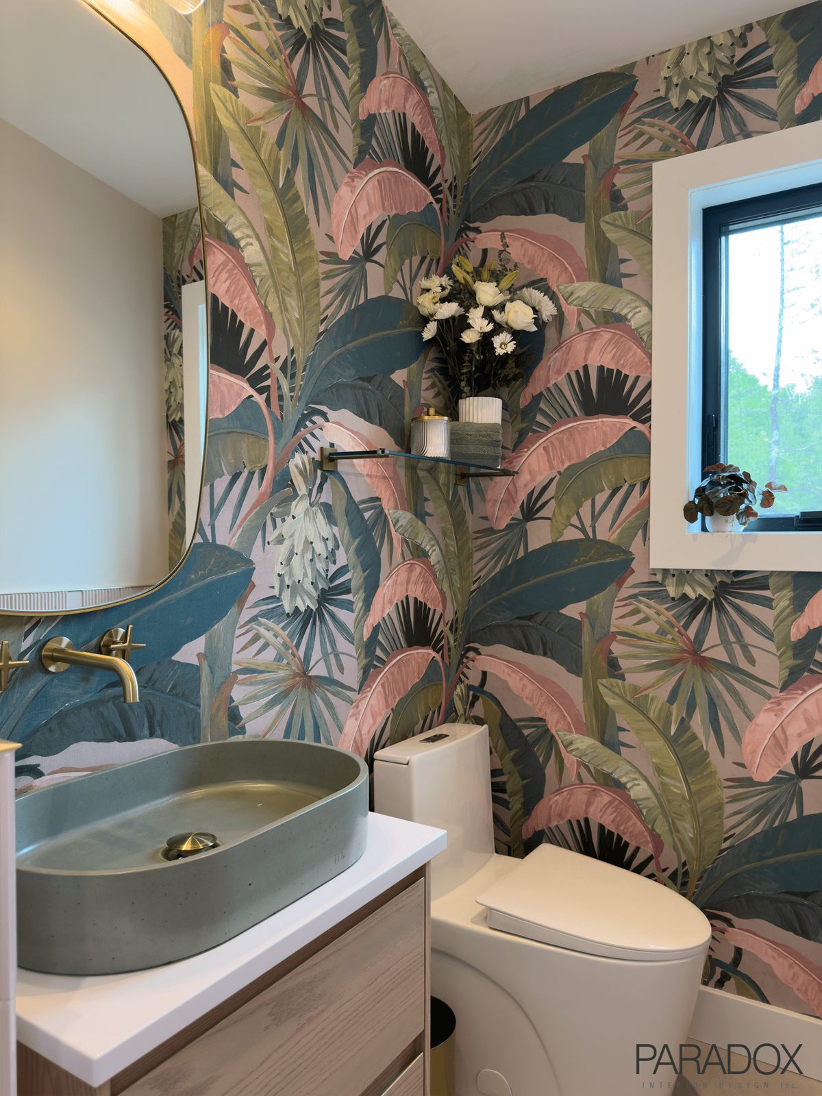 Powder room with bold patterned wallpaper, green concrete sink and pink wall tile