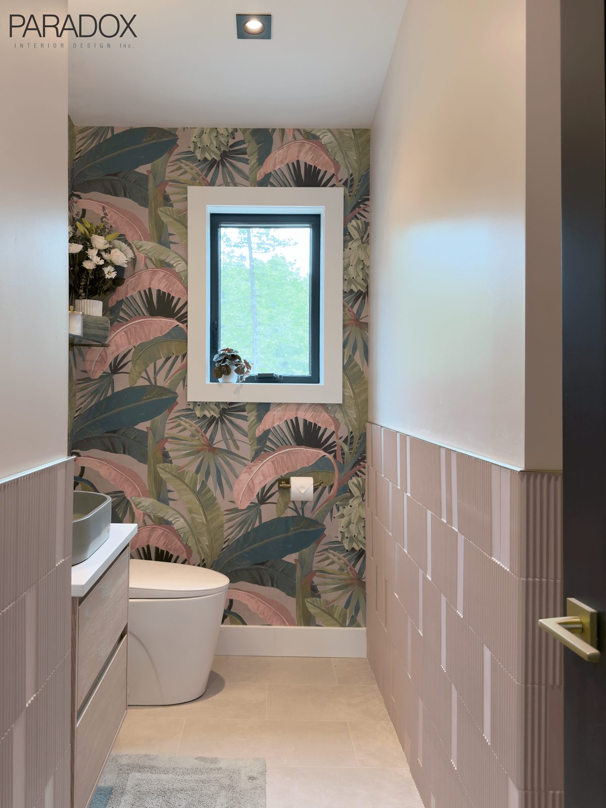 Powder room with bold patterned wallpaper, green concrete sink and pink wall tile, view 2
