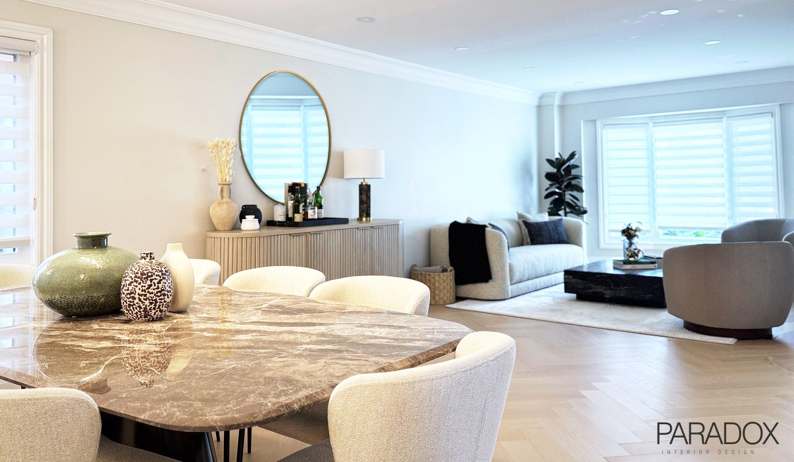Richmond Hill living and dining room with herringbone hardwood floors, a marble dining table, a black marble coffee table and wall paneling, view 2