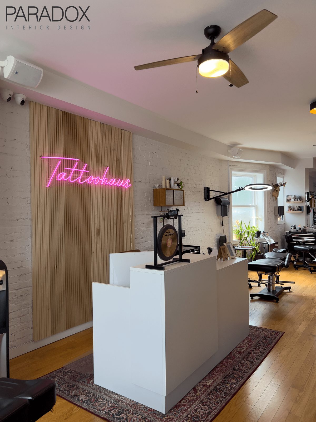Tattoo studio interior in Toronto designed with warm, residential-style lounge areas and workstations