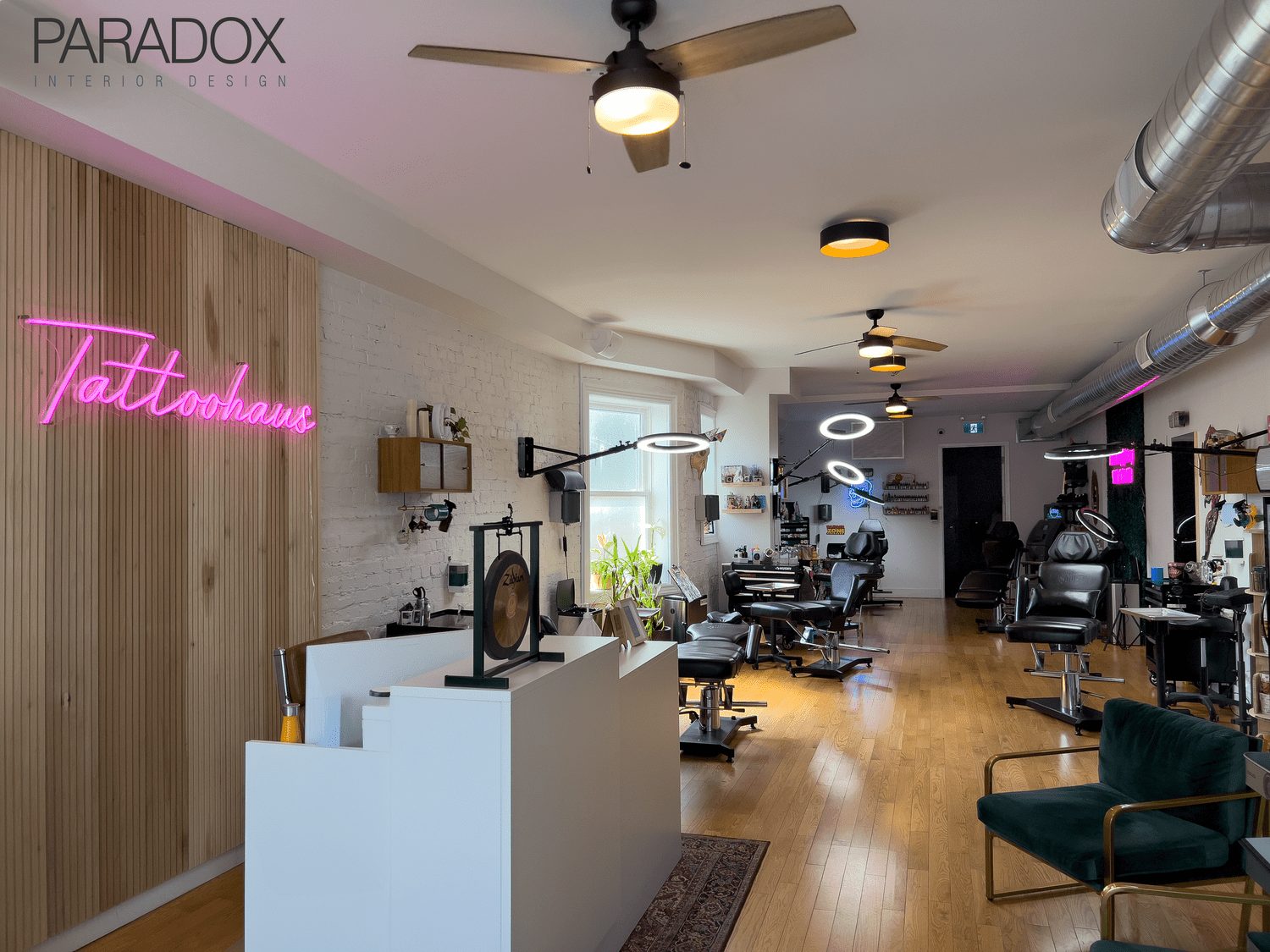 Tattoo studio interior in Toronto designed with warm, residential-style lounge areas and workstations, view 2