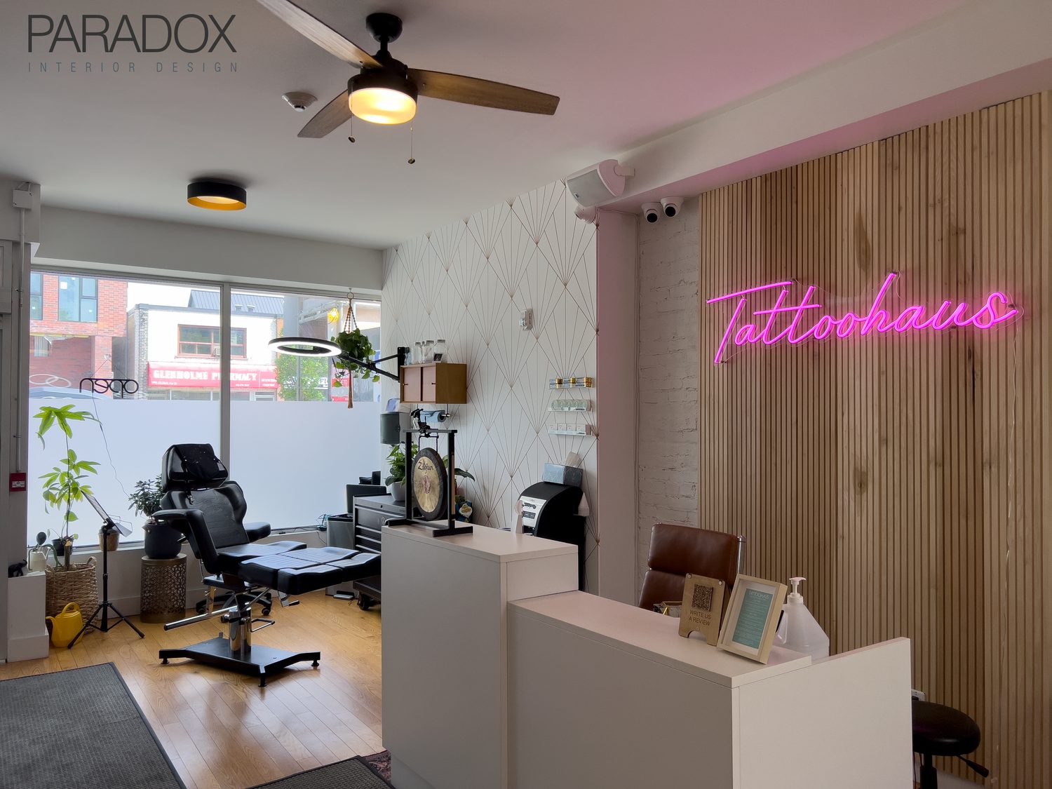 Tattoo studio interior in Toronto designed with warm, residential-style lounge areas and workstations, view 3